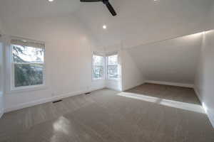 Additional living space with lofted ceiling, carpet, ceiling fan, and recessed lighting