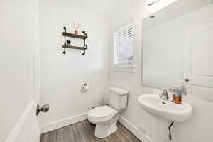 Bathroom with wood finished floors and baseboards