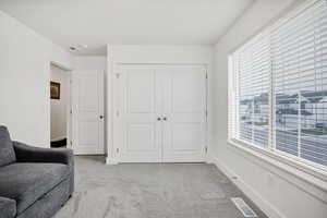 Sitting room featuring light carpet and baseboards