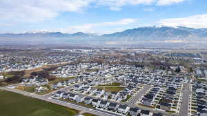 Aerial view of property's location with nearby suburban area and mountains
