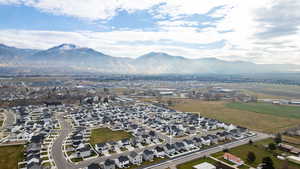 Aerial overview of property's location with a mountain backdrop and nearby suburban area