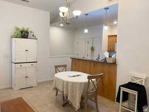 Dining room featuring a chandelier, light tile patterned flooring, and recessed lighting