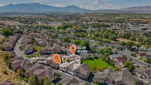 Aerial view of property's location with a mountainous background and nearby suburban area