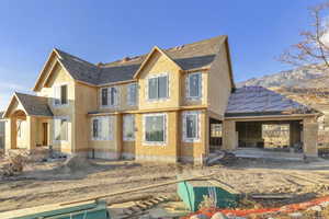 Rear view of property featuring a patio area and a shingled roof
