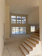 Stairs featuring a high ceiling