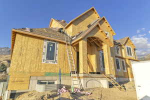 View of front of property with roof with shingles