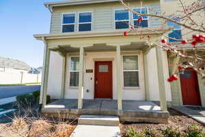 View of front of home with a porch and stucco siding