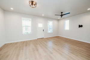 Foyer entrance with light wood finished floors, a ceiling fan, and recessed lighting