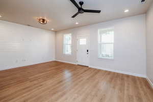 Entryway featuring light wood-type flooring, ceiling fan, and recessed lighting