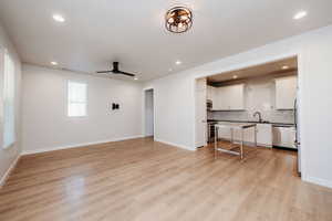 Unfurnished living room with light wood finished floors, ceiling fan, and recessed lighting