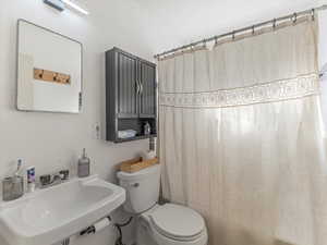 Bathroom with a shower with shower curtain