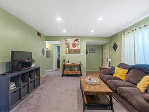 Living room featuring carpet and recessed lighting