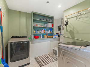 Washroom featuring washing machine and clothes dryer and light floors