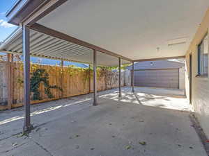 Fenced backyard with an outbuilding
