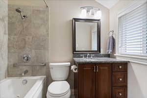 Bathroom featuring vanity and  shower combination