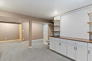 Finished below grade area with light carpet and recessed lighting