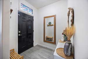 Entryway featuring light wood-style floors and baseboards