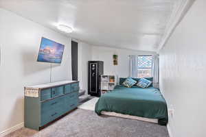 Bedroom with carpet and vaulted ceiling