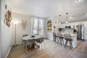 Dining area featuring light wood-type flooring and baseboards