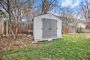 View of shed with a fenced backyard