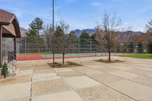 View of property's community with a tennis court and a mountain view