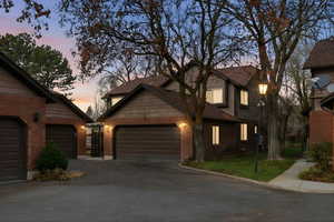 View of front of home featuring brick siding and asphalt driveway