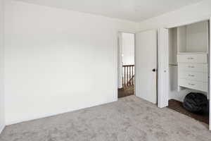 Unfurnished bedroom featuring carpet floors and a closet