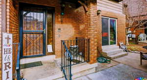 View of exterior entry featuring brick siding