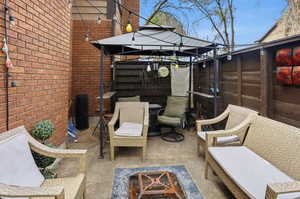 View of patio / terrace with a gazebo and a fire pit