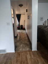 Hallway with baseboards and wood finished floors
