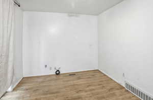 Washroom with light wood-type flooring and a textured ceiling