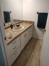 Bathroom with vanity and dark wood-type flooring