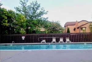 Community pool with a patio area