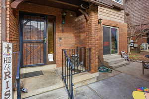 View of exterior entry with brick siding