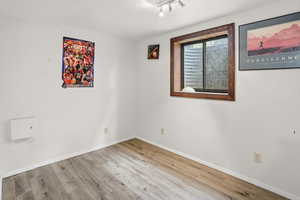 Empty room featuring wood finished floors and baseboards
