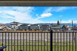 Water view with a mountain backdrop and nearby suburban area