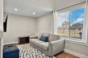 Living area with wood finished floors and recessed lighting