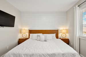 Bedroom with wood walls