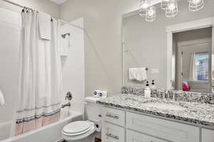 Full bathroom featuring shower / bath combo with shower curtain and vanity