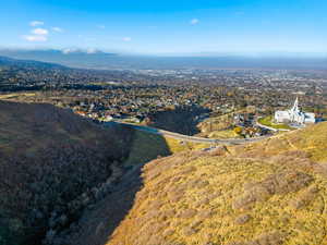 Aerial view of property and surrounding area featuring mountains
