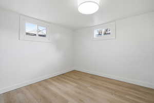 Below grade area with light wood finished floors and baseboards