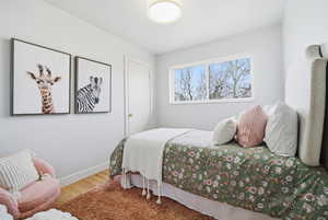 Bedroom featuring wood finished floors and baseboards