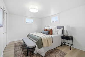 Bedroom with light wood finished floors and a closet