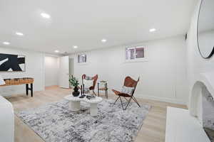 Living area featuring light wood-type flooring and recessed lighting