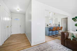 Entrance foyer featuring light wood-style flooring and baseboards
