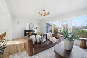 Living area with a chandelier and wood-type flooring