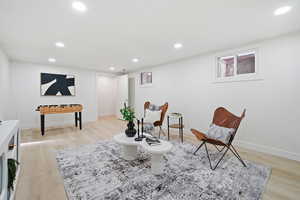 Sitting room with light wood-style floors and recessed lighting