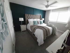 Bedroom with carpet floors, an accent wall, and a ceiling fan