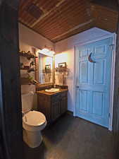 Bathroom with wood ceiling and vanity