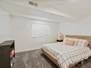 Bedroom featuring dark carpet and recessed lighting